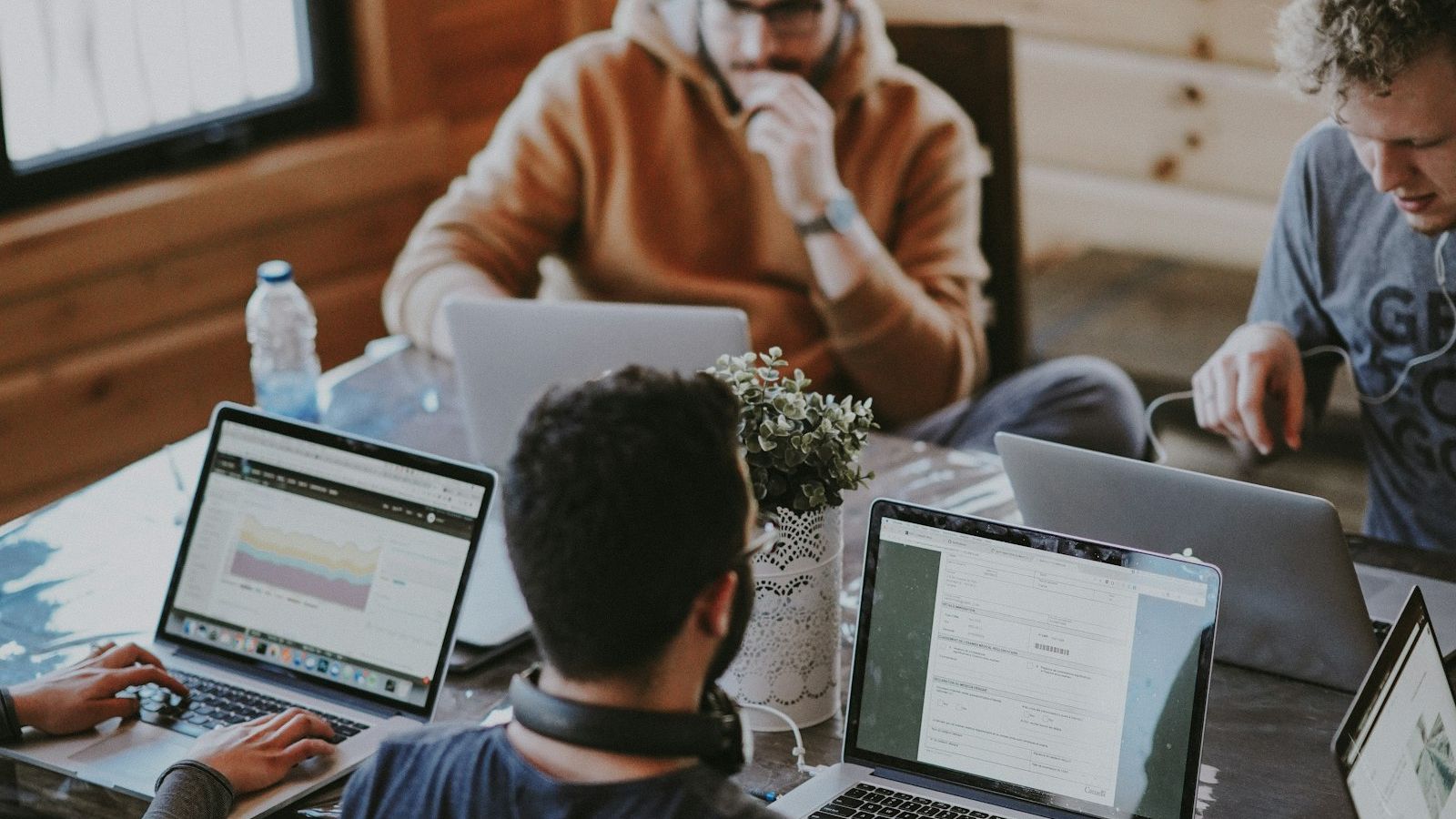 Dirigeant de petite entreprise utilisant un assistant d'intelligence artificielle sur son ordinateur portable.